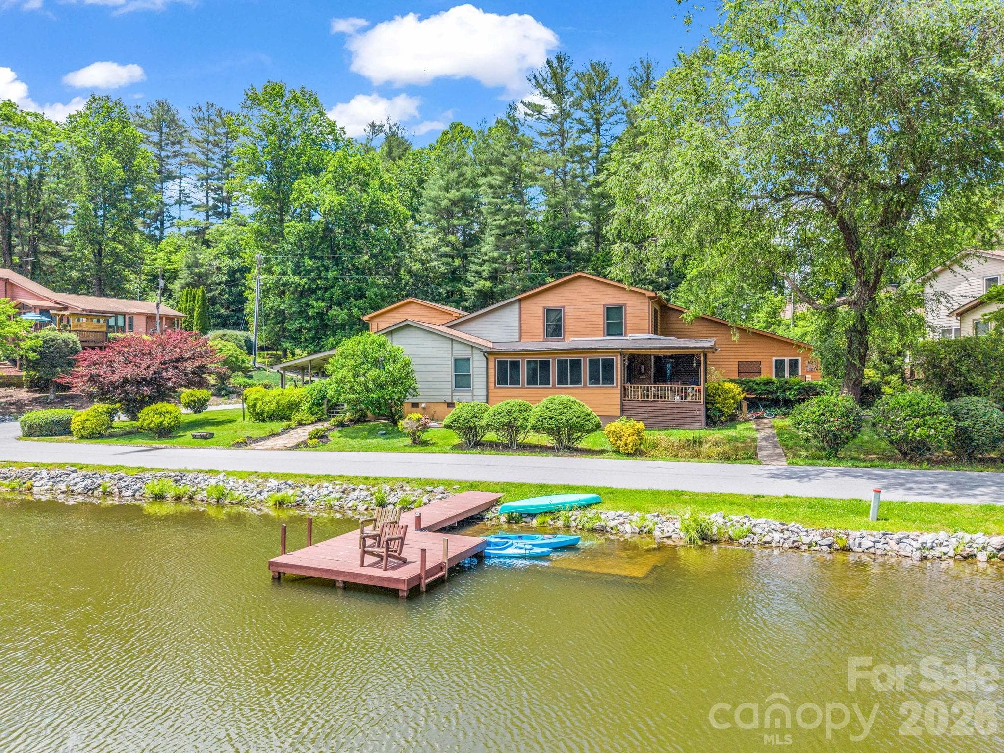 View across lake looking at front of the townhouse - 117 Willow Way, Hendersonville