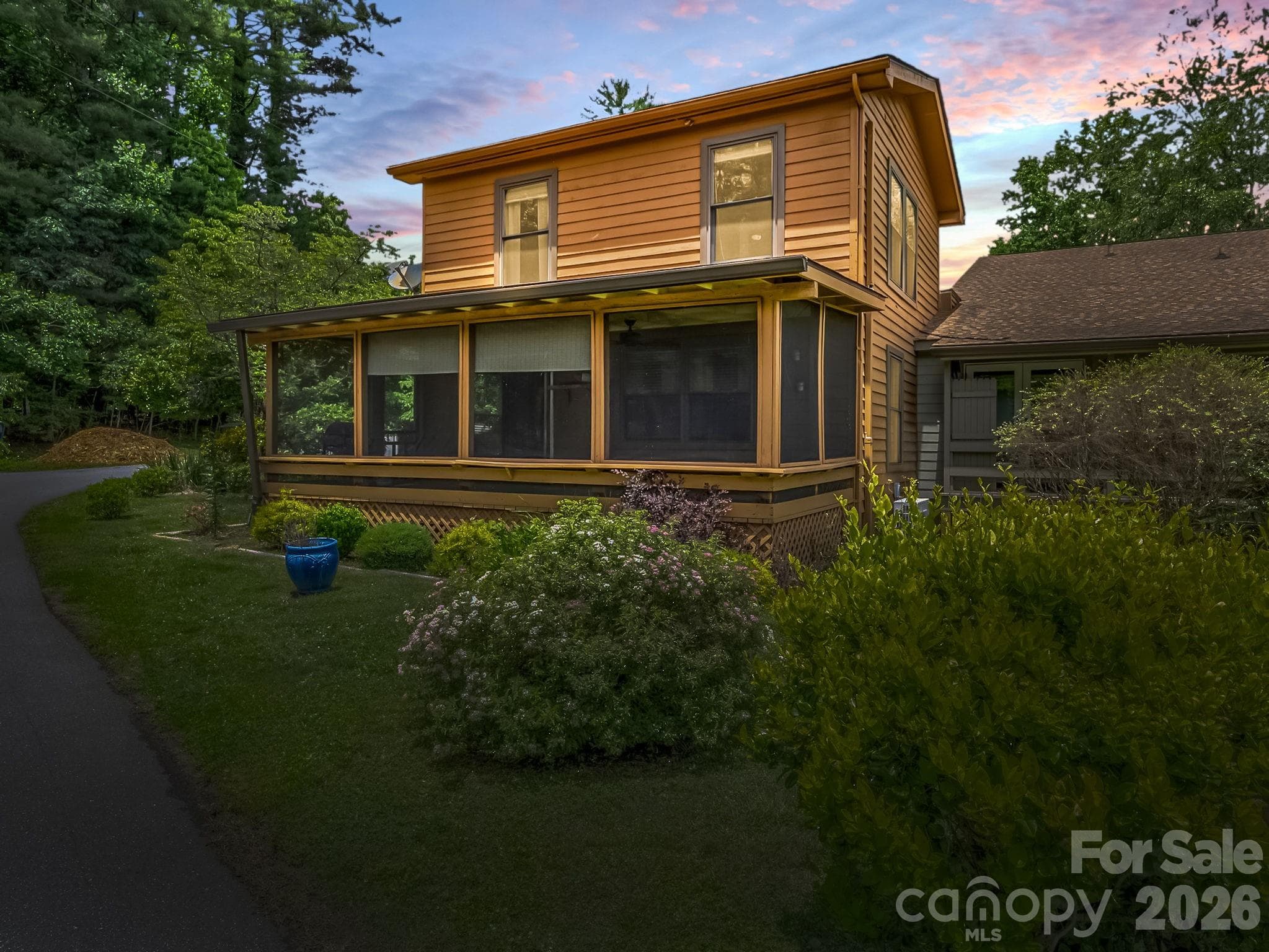 Side of the townhome showing the screened in porch. - 117 Willow Way, Hendersonville