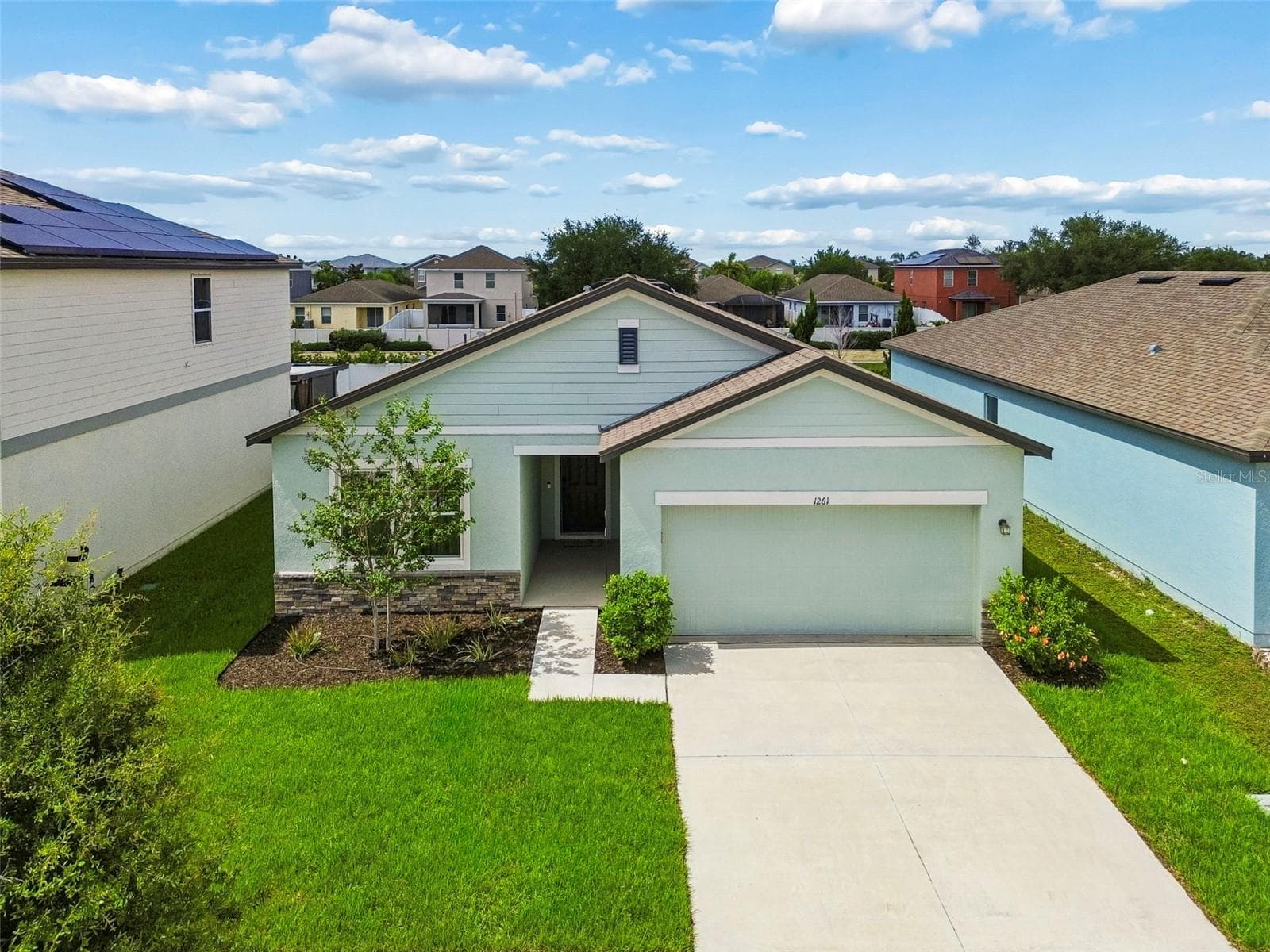 Beautiful modern curb appeal! Featuring contrasting dark trim, stone accents, and meticulously maintained lawn! - 1261 ANCHOR BEND DR, RUSKIN