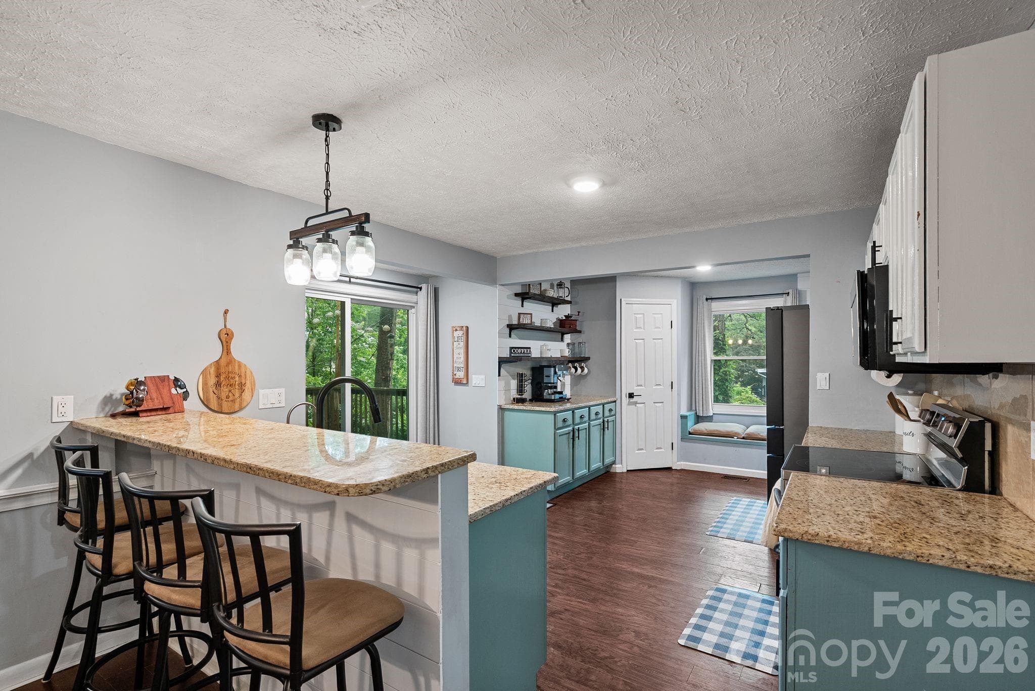 A convenient breakfast bar - note the door to the deck and the cozy window seat! - 4 Beechwood Lakes Drive, Hendersonville