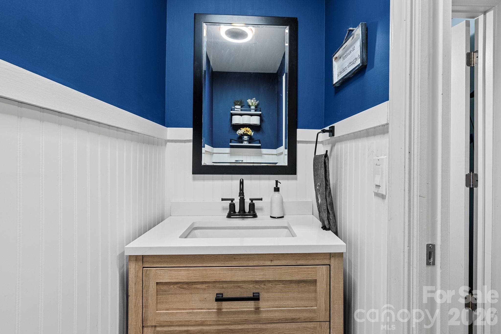 Main level powder room tucked in hall for convenience and privacy. - 4 Beechwood Lakes Drive, Hendersonville