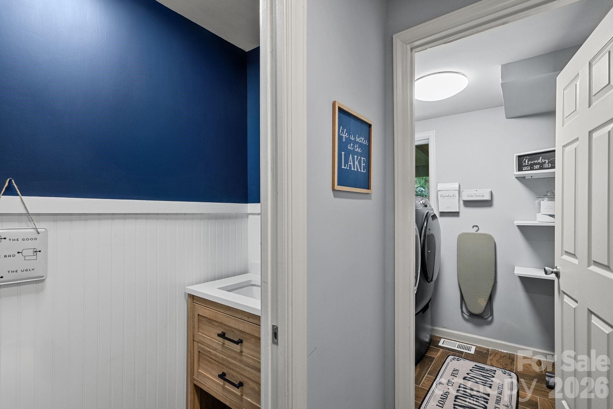View of powder room and laundry room in hall off garage. - 4 Beechwood Lakes Drive, Hendersonville