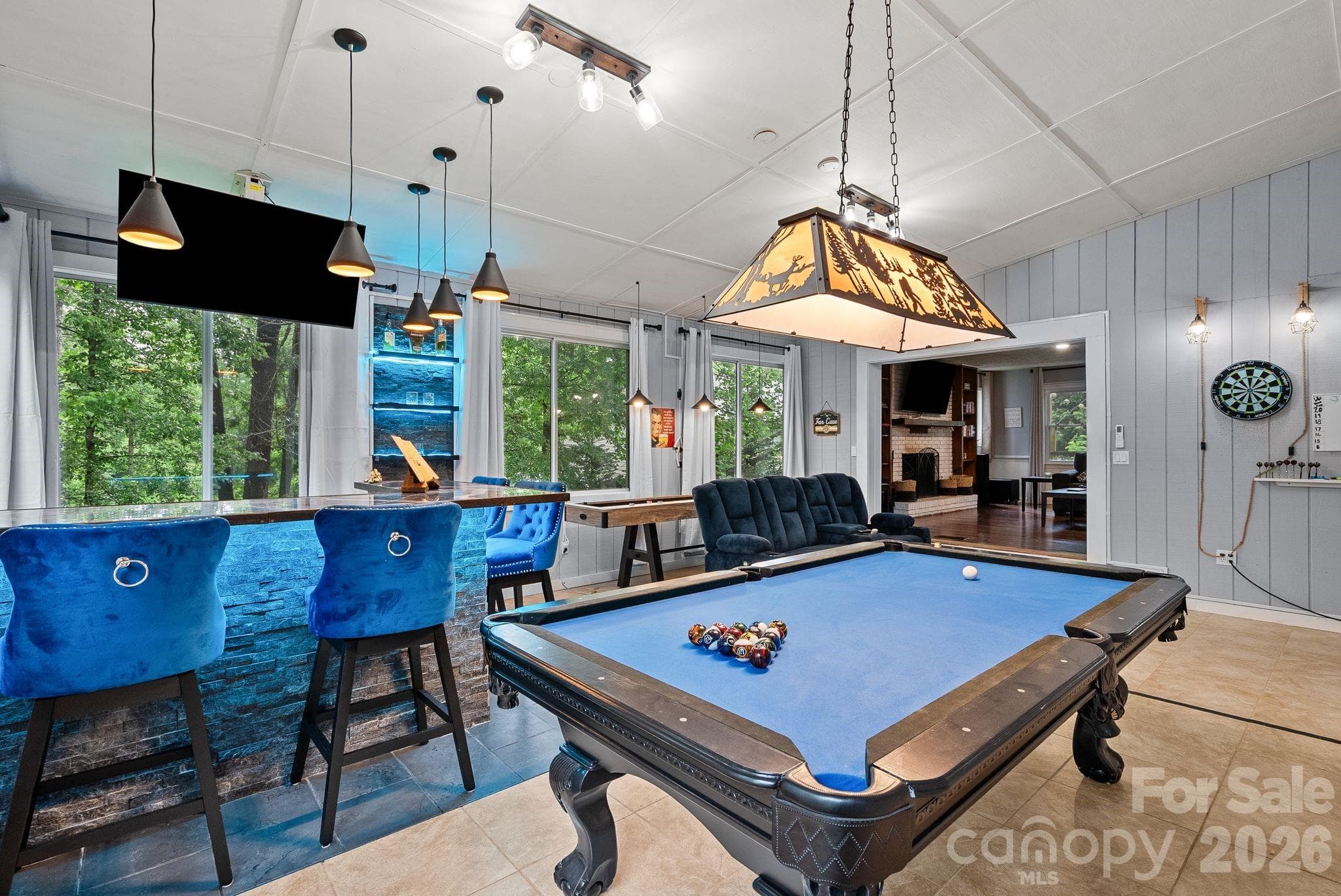 The sunroom is heated and cooled for year round use & features a custom bar & gameroom + media area. - 4 Beechwood Lakes Drive, Hendersonville