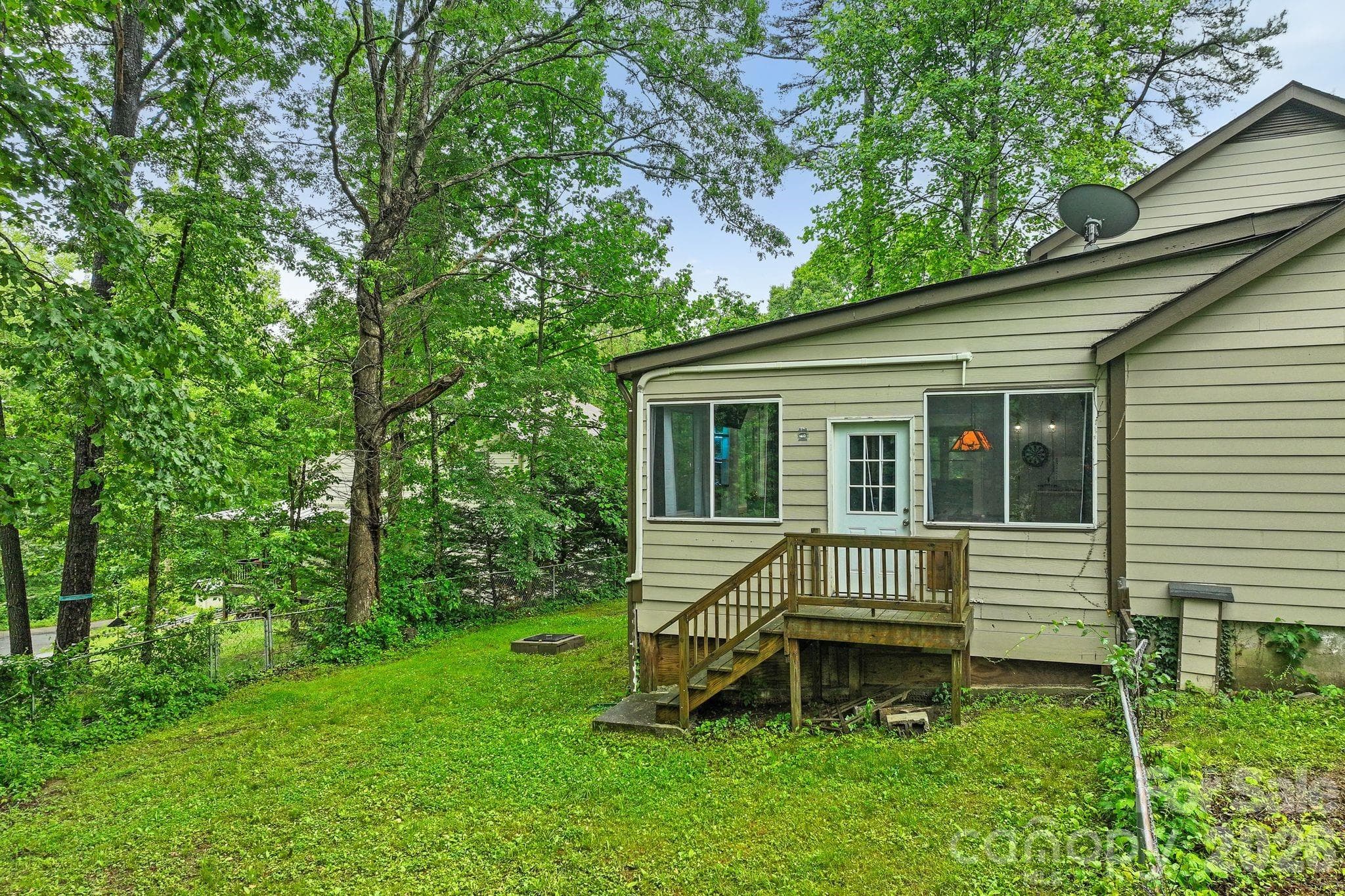 Step outside the sunroom and step into your fenced back yard with firepit. - 4 Beechwood Lakes Drive, Hendersonville