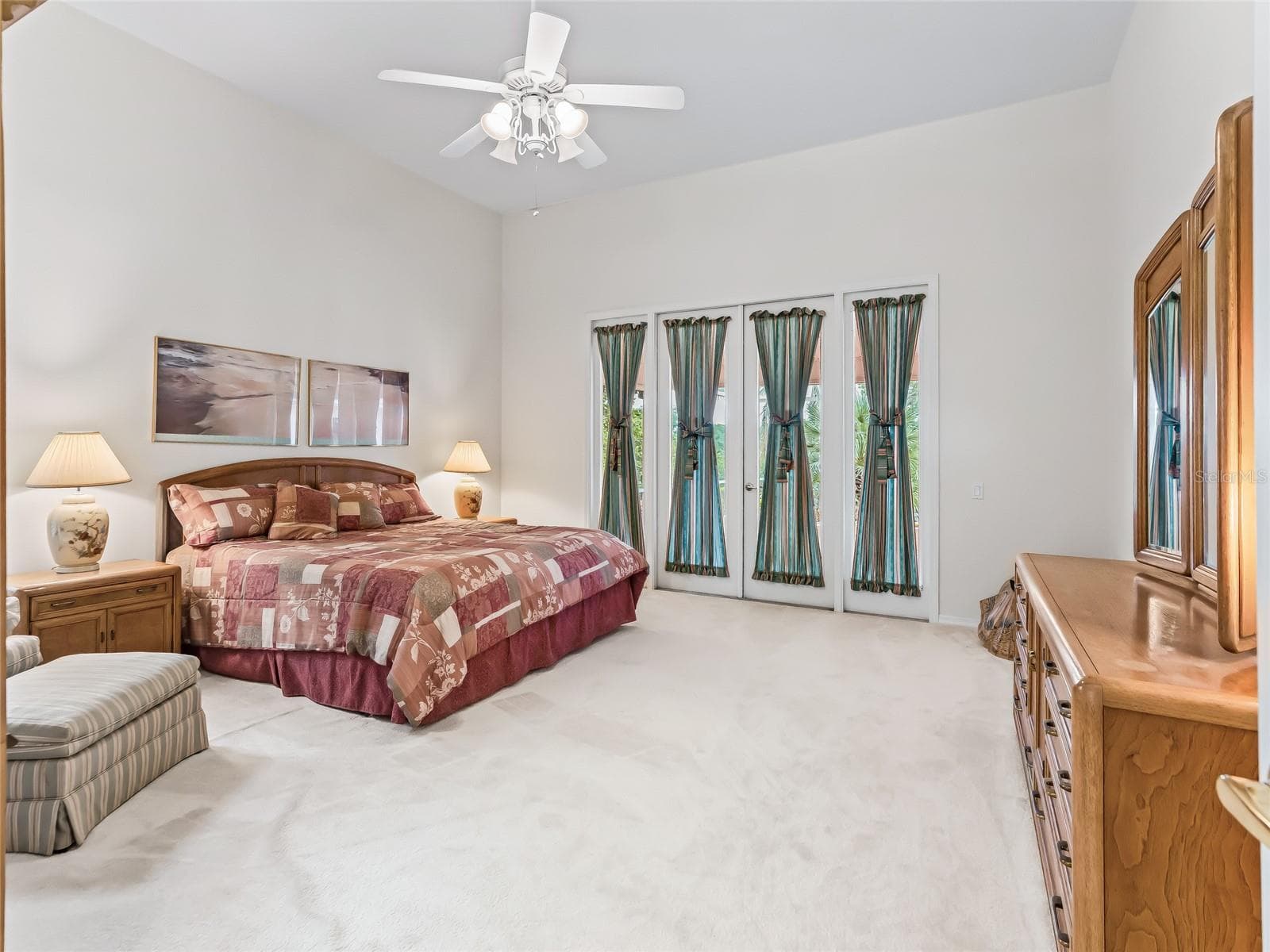Primary Bedroom with French door to enclosed lanai - 5321 GREENS DR, LADY LAKE