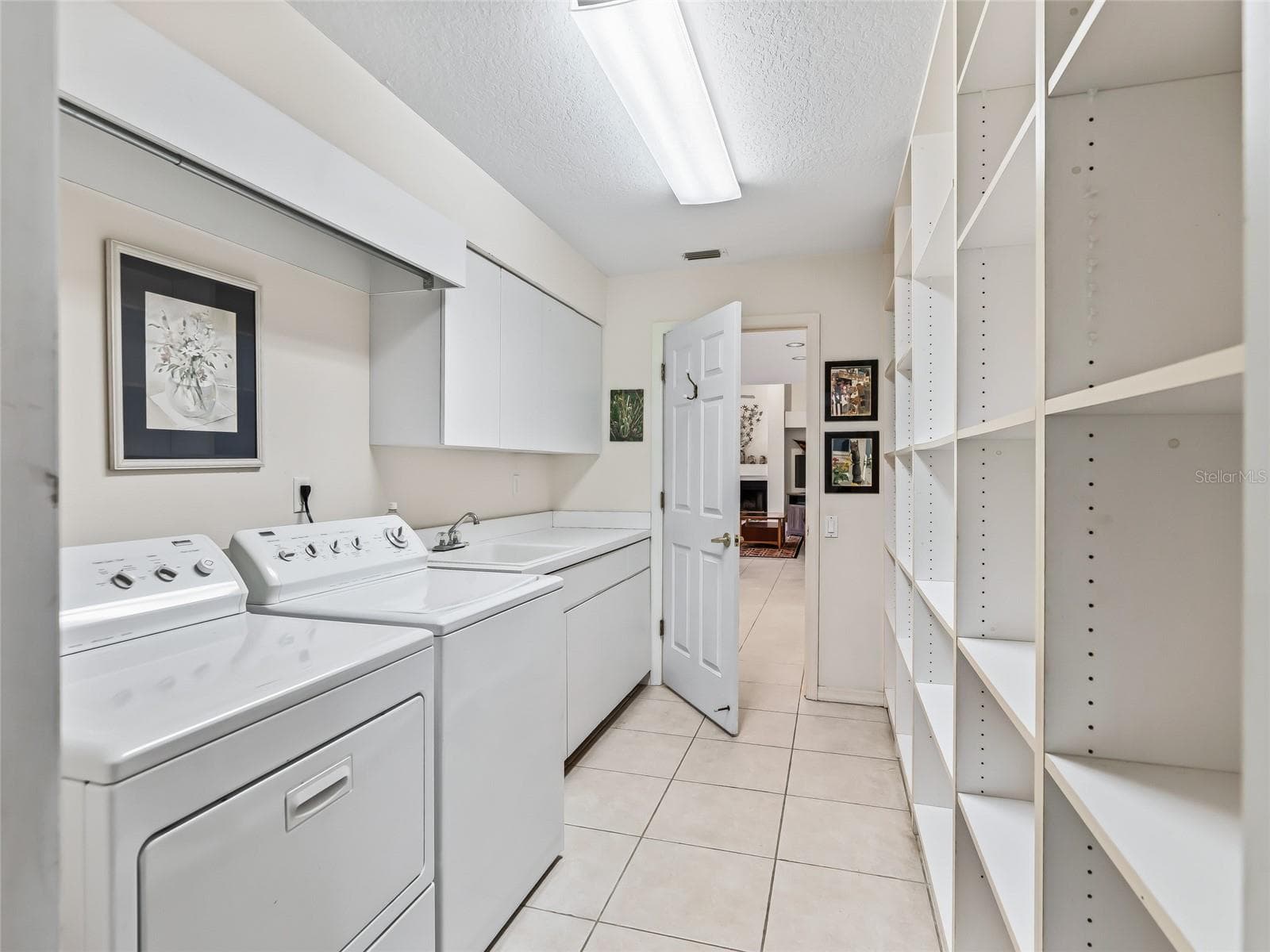 Laundry room has LOTS of storage - 5321 GREENS DR, LADY LAKE