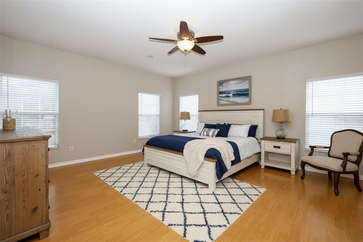 Spacious Apopka Primary Bedroom provides room for a king-size bedroom set, sitting area, and additional furnishings while maintaining a comfortable retreat-like feel. - 1349 VALLEY PINE CIR, APOPKA