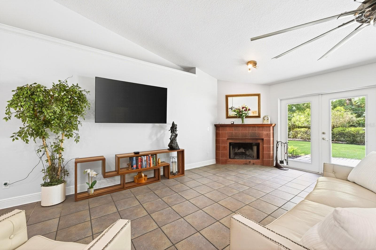 The beautiful MASONRY WOOD-BURNING FIREPLACE creates a cozy focal point for the home. - 2706 HARGILL DR, ORLANDO