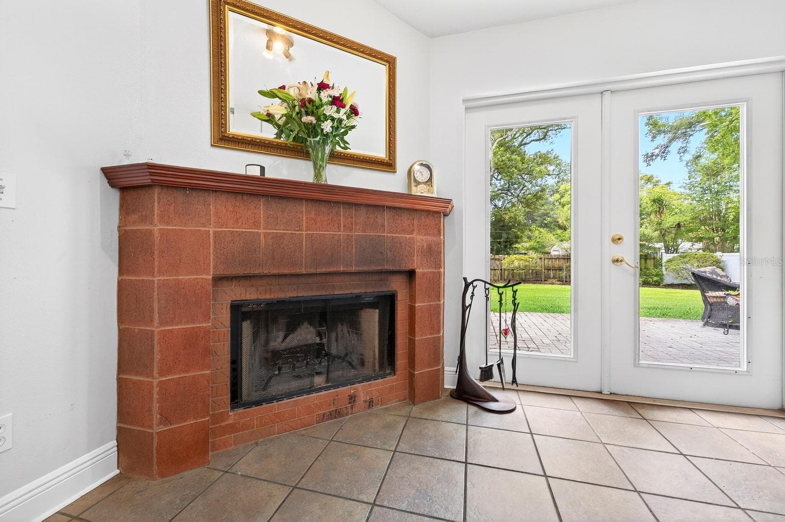The beautiful MASONRY WOOD-BURNING FIREPLACE creates a cozy focal point for the home. - 2706 HARGILL DR, ORLANDO