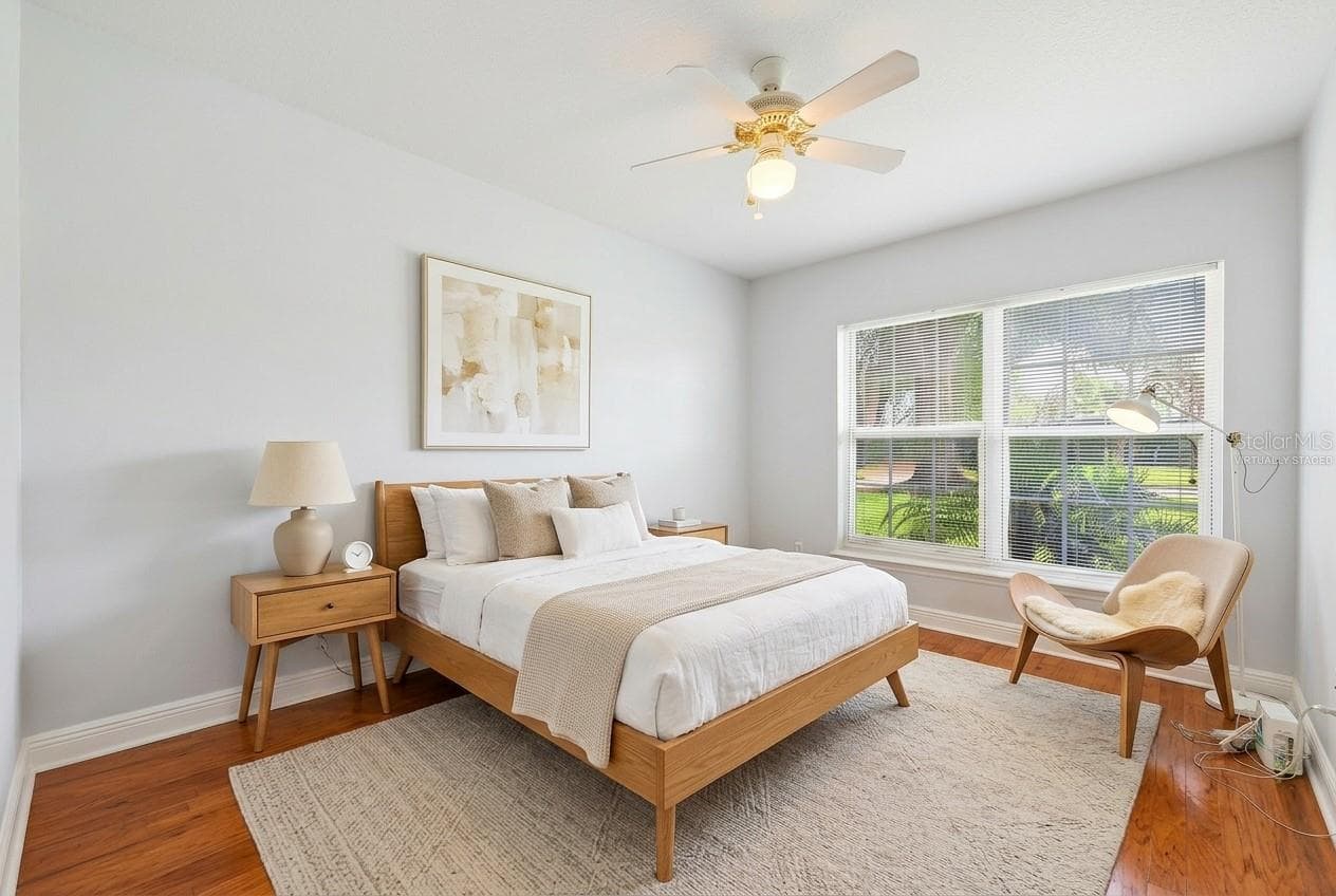 Two additional bedrooms provide flexibility for family, guests, or a home office—one featuring distinctive SLATE FLOORING (2018) and the other WARM WOOD FLOORING—both conveniently located near the second full bath. Bedroom 3 Virtually Staged - 2706 HARGILL DR, ORLANDO