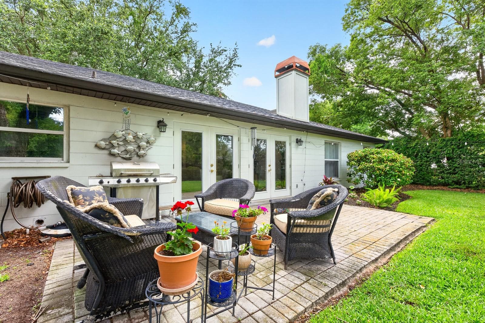 A brick patio creates the perfect outdoor gathering space. - 2706 HARGILL DR, ORLANDO