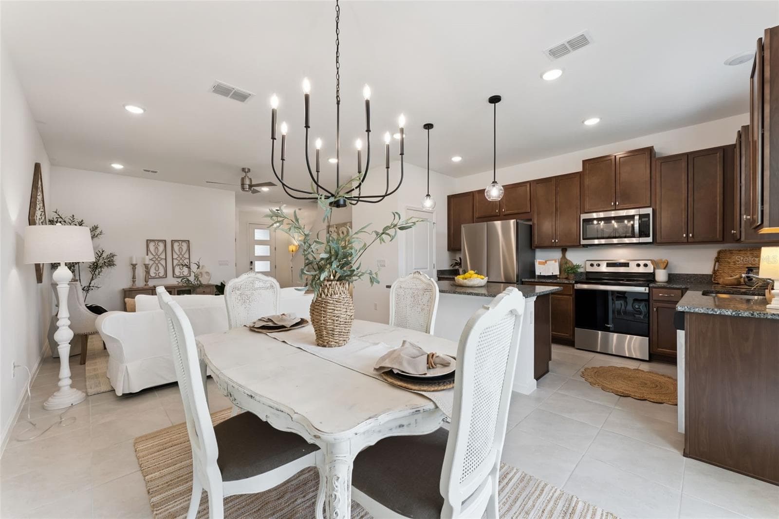 Dining Room off of Kitchen overlooking Family Room and the OUTDOORS - 1070 SPRING PALMS LOOP, ORLANDO