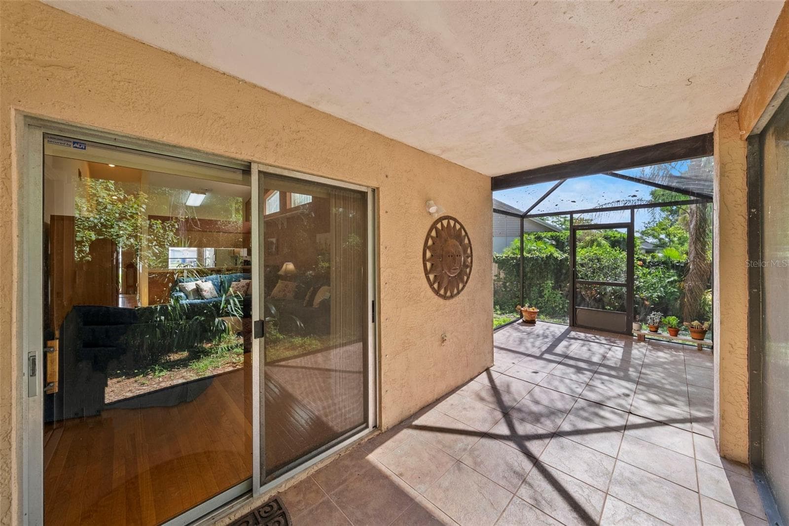 Covered lanai with sliding glass door access from the home. - 8601 TWIN FARMS PL, TAMPA