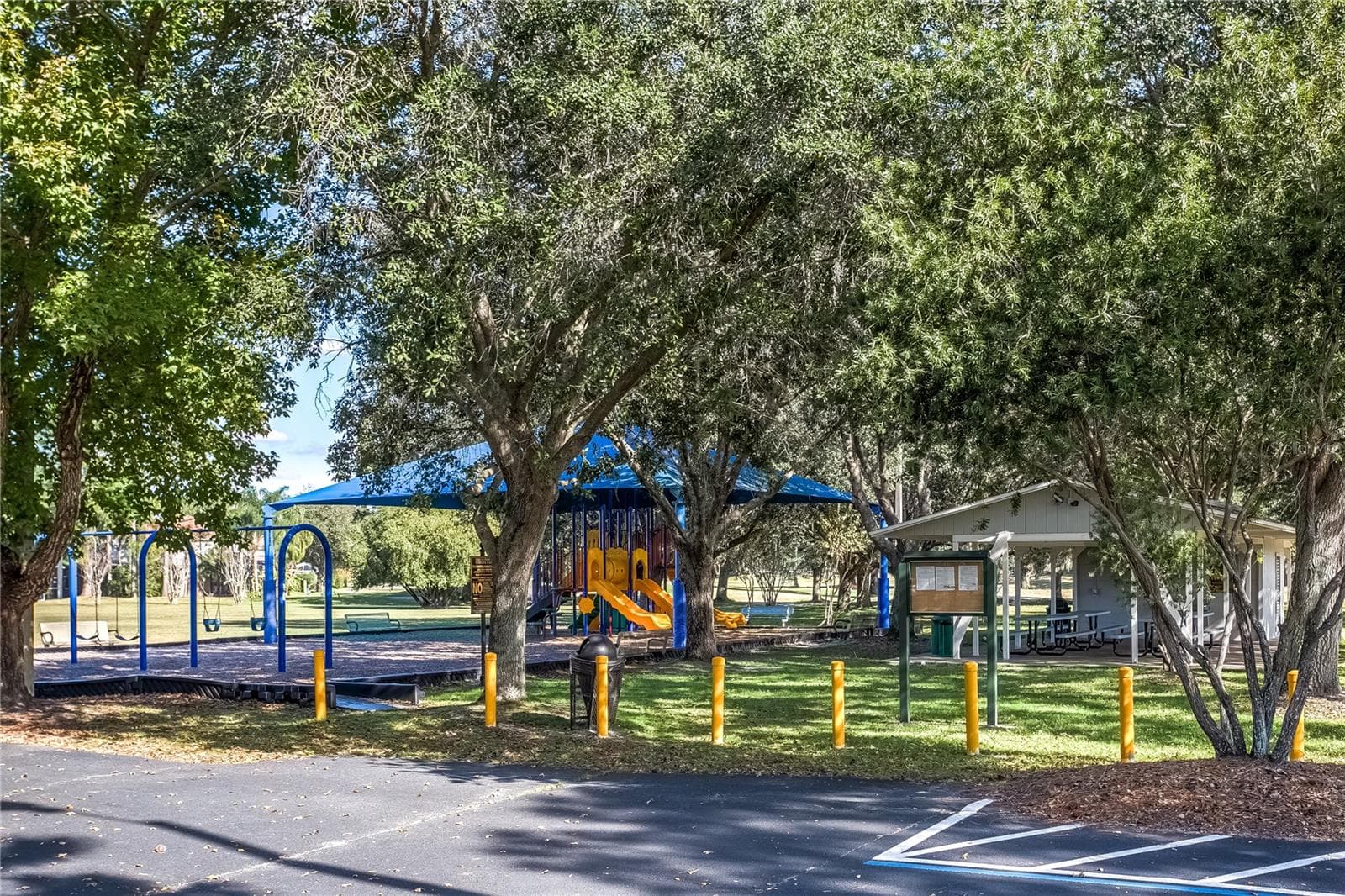 Community playground with shaded seating and parking nearby. - 8601 TWIN FARMS PL, TAMPA