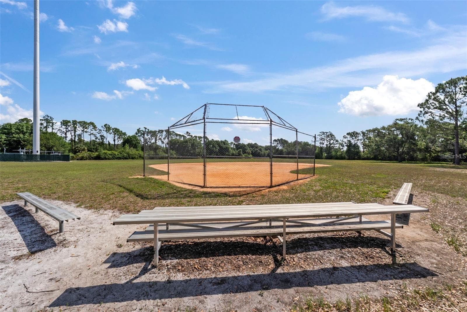 Community baseball field with seating and open space. - 8601 TWIN FARMS PL, TAMPA