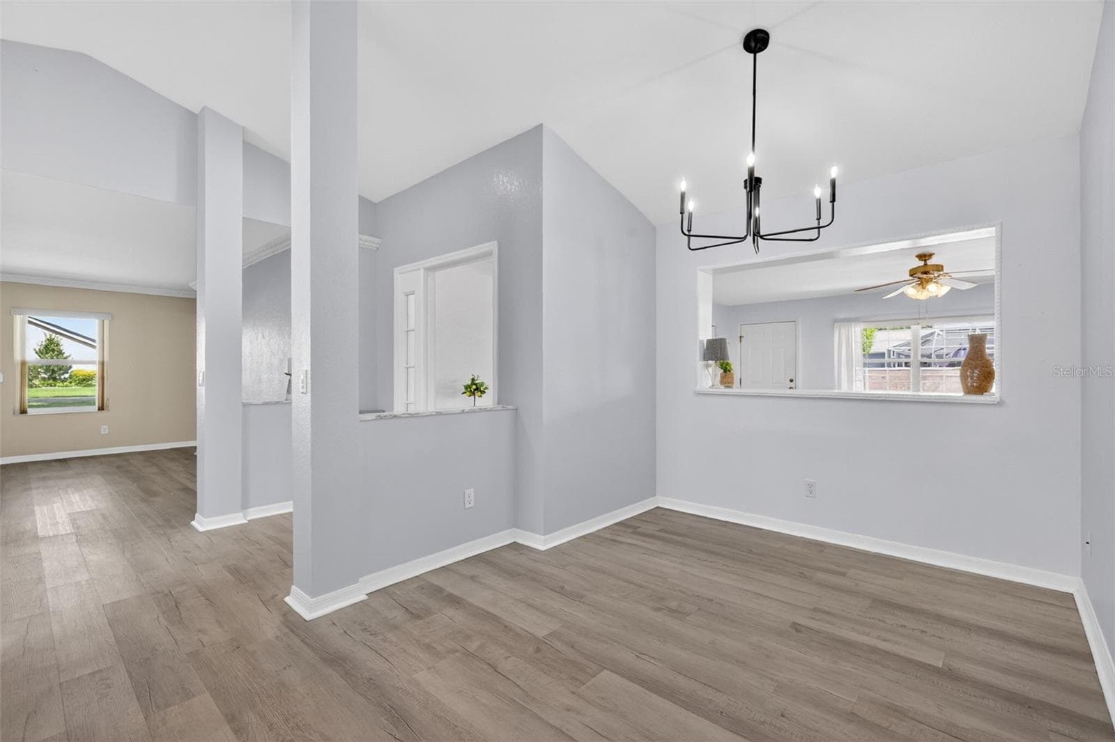 8x12 dining area featuring an upgraded light fixture and convenient pass-through window for easy entertaining. - 17808 SE 115TH CT, SUMMERFIELD