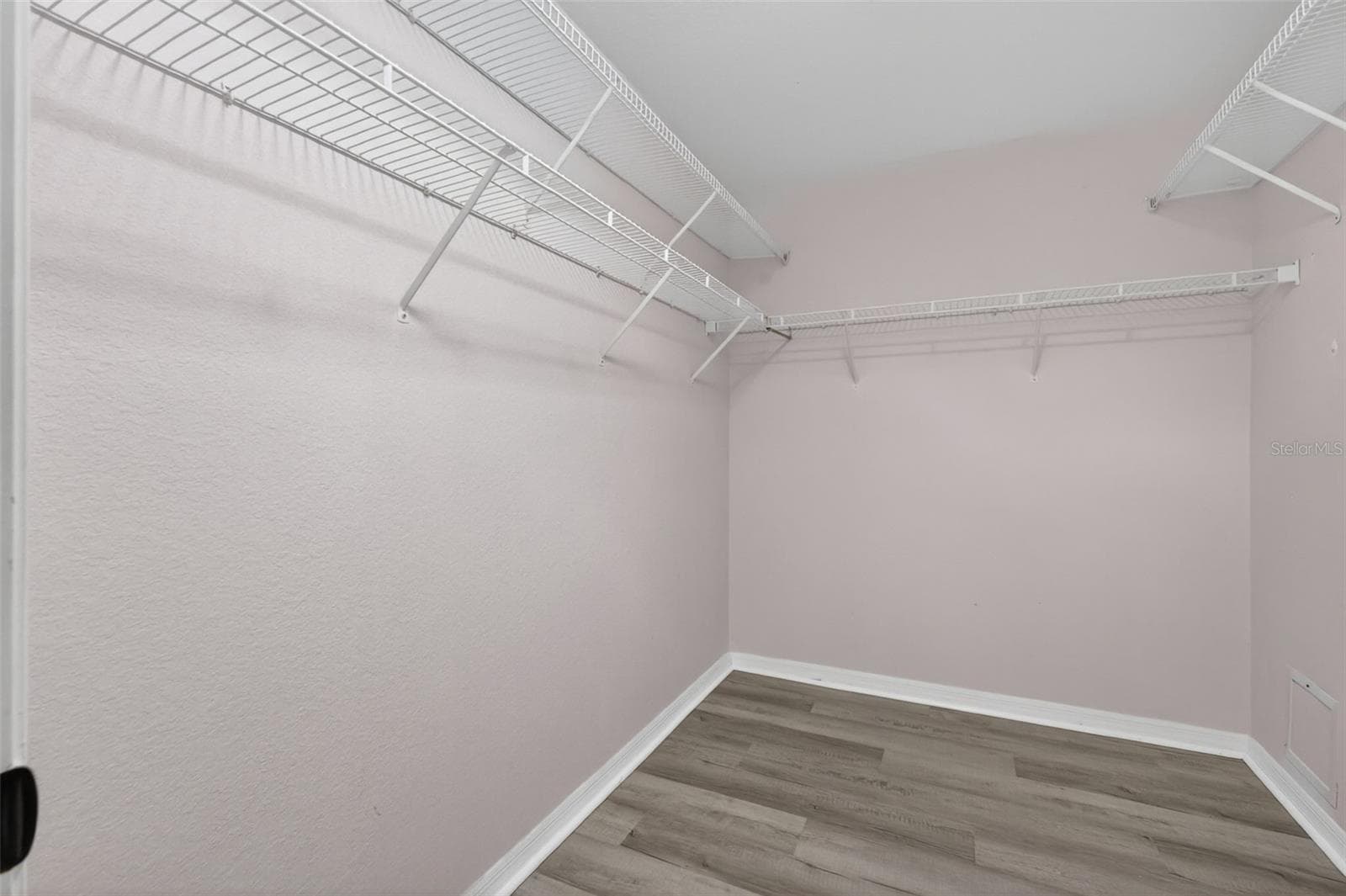 Walk in closet features a solar tube for natural lighting. - 17808 SE 115TH CT, SUMMERFIELD