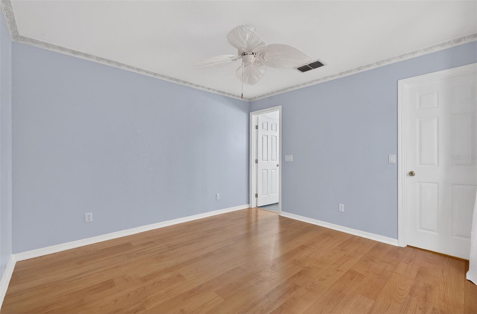 Primary Bedroom 2 with laminate flooring and walk in closet. - 17808 SE 115TH CT, SUMMERFIELD