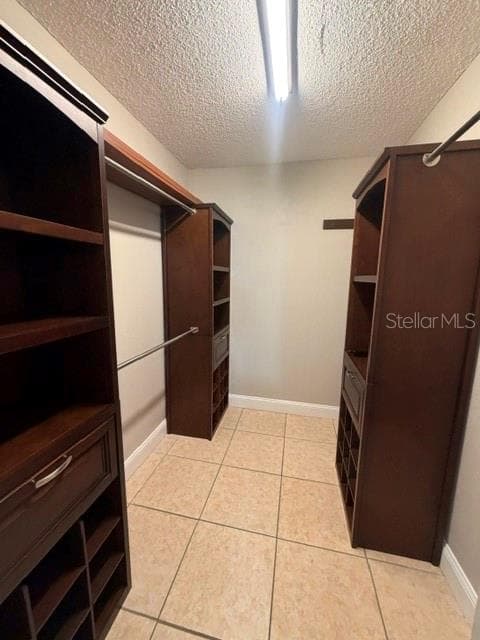 Primary walk-in closet w/ built-in cabinetry - 700 MIRROR TER NW #507, WINTER HAVEN
