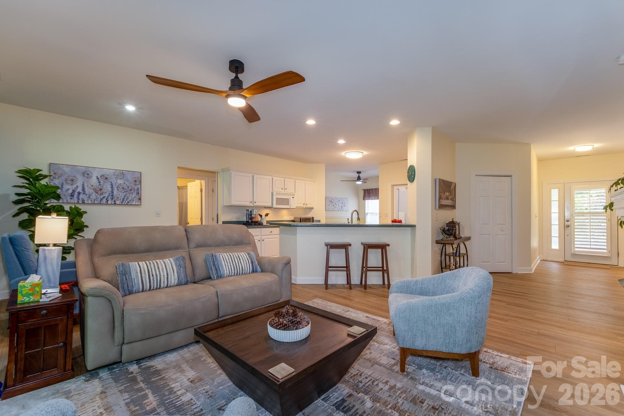Spacious Open Floor Plan – Bright and open living room with updated flooring, modern ceiling fan, breakfast bar seating, and excellent flow for entertaining. - Brevard