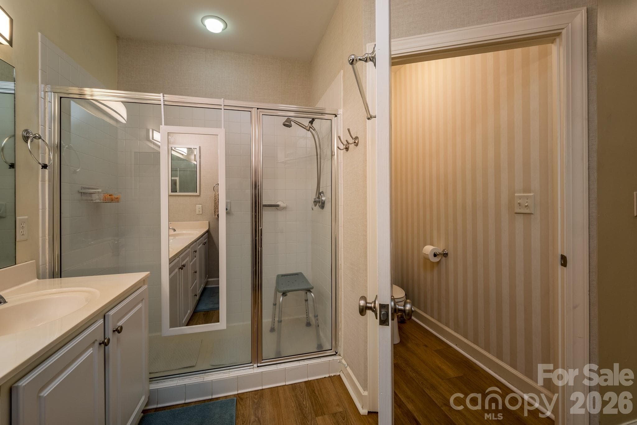 Primary Bathroom with Walk-In Shower – Spacious primary bath featuring a large walk-in shower, private water closet, and functional layout. - 99 Ridgetop Circle, Brevard