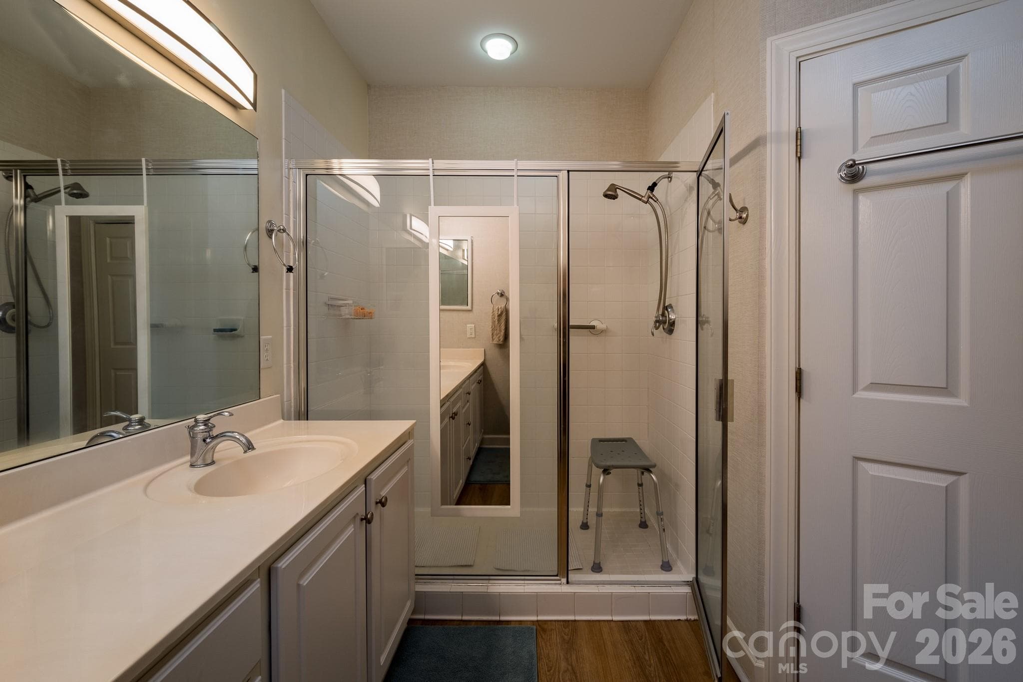 Spacious Walk-In Shower Bath – Primary bathroom featuring an oversized walk-in shower, ample vanity space, and easy accessibility. - 99 Ridgetop Circle, Brevard