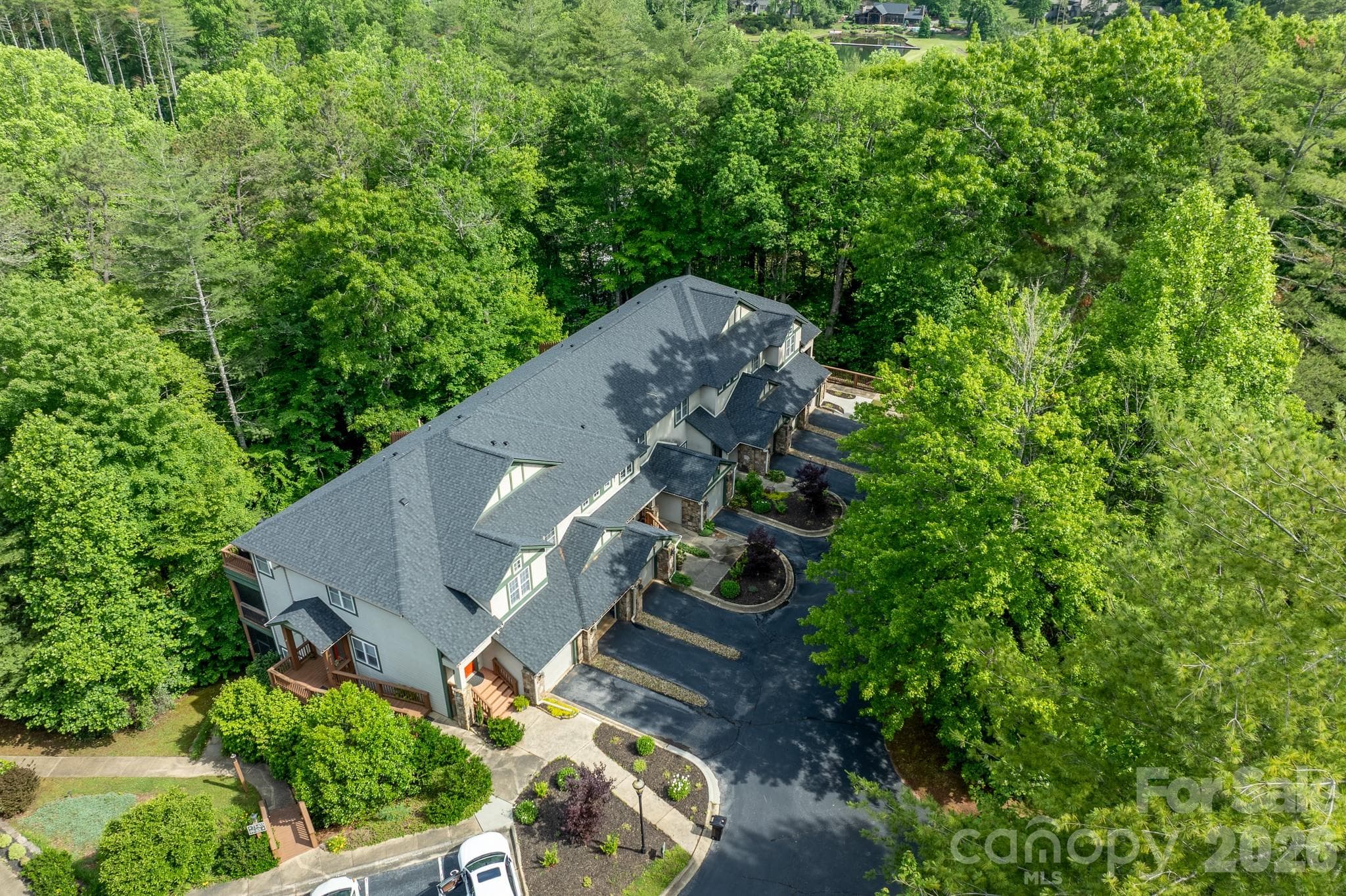 Beautifully Maintained Community Setting – Aerial perspective highlighting the attractive architecture, landscaped grounds, and peaceful wooded surroundings. - 99 Ridgetop Circle, Brevard