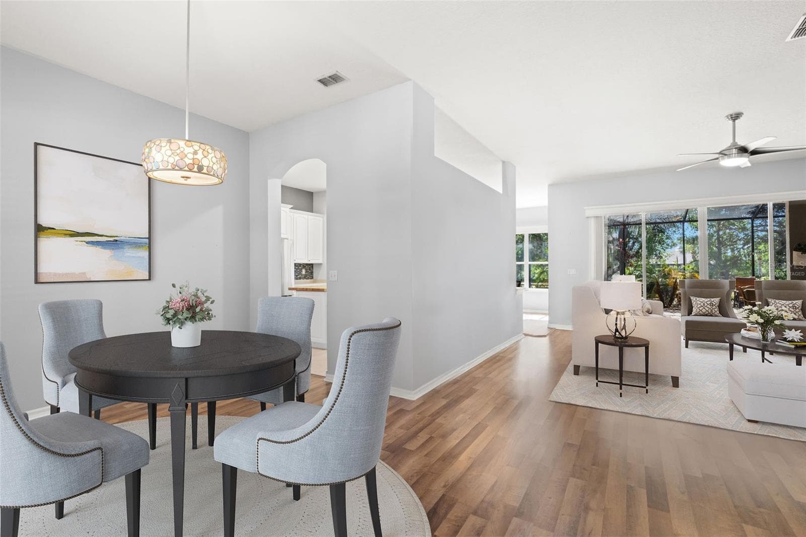 Virtually Staged - Dining Room and Living Room with Kitchen Access - 1305 CRYSTAL GREENS DR, SUN CITY CENTER