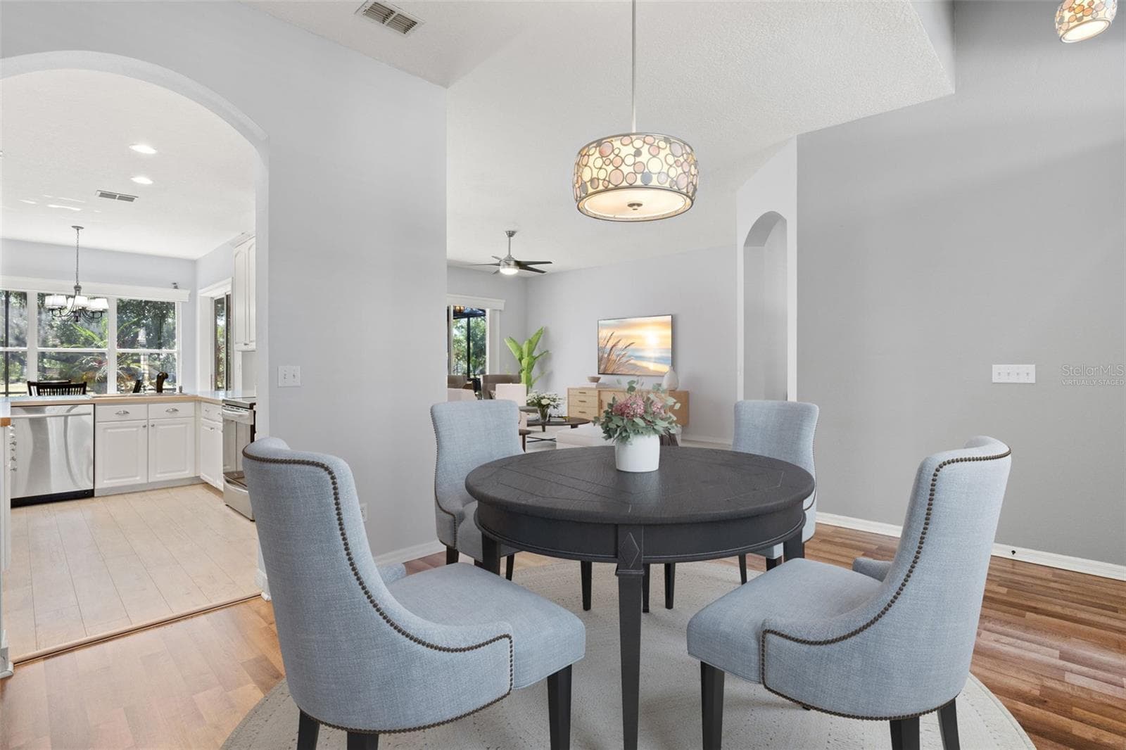 Virtually Staged - Dining Room and Living Room with Kitchen Access - 1305 CRYSTAL GREENS DR, SUN CITY CENTER