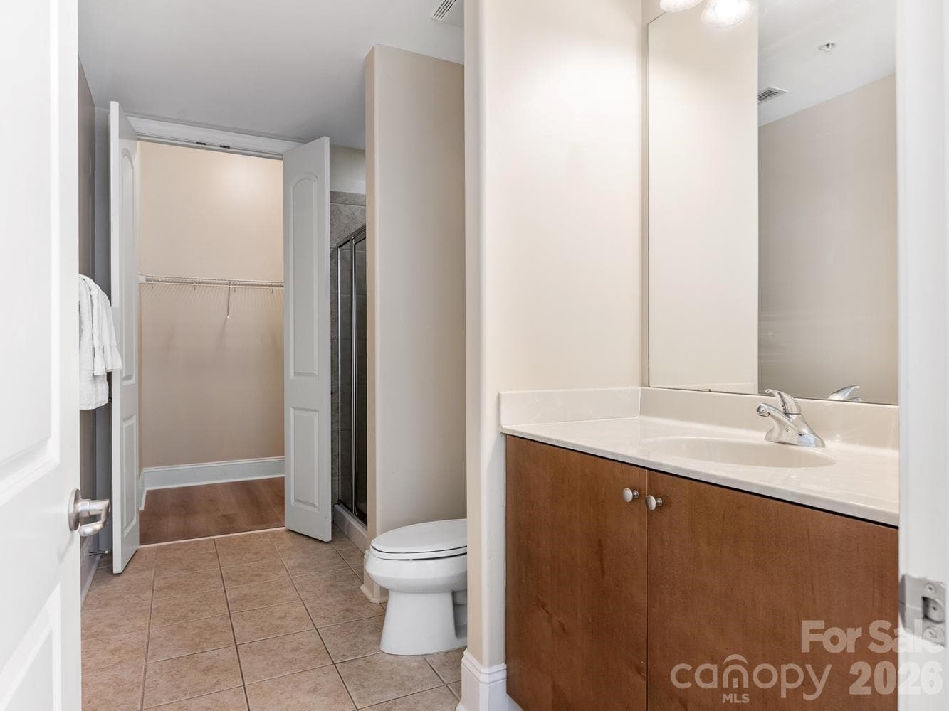 Primary bathroom with walk-in closet and stall shower - 4625 Piedmont Row Drive, Charlotte