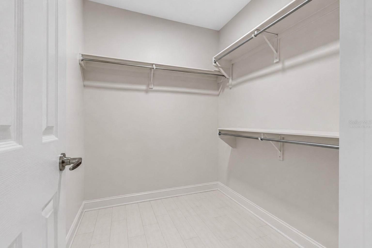Virtually staged walk- in closet in primary bedroom - 1794 SANTA BARBARA DR, DUNEDIN