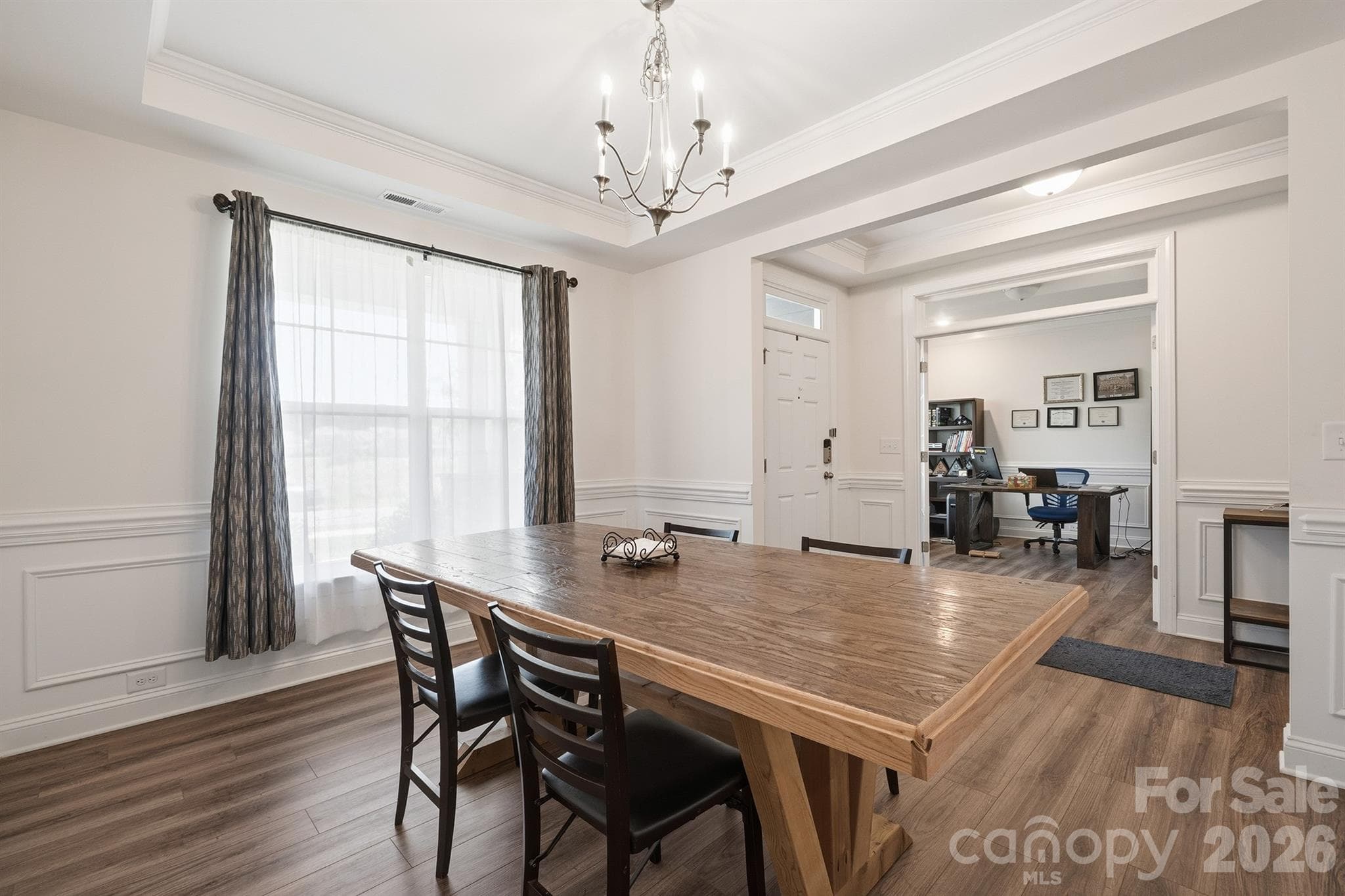 Dining Room Featuring Tray Ceilings and Wainscoting - Waxhaw