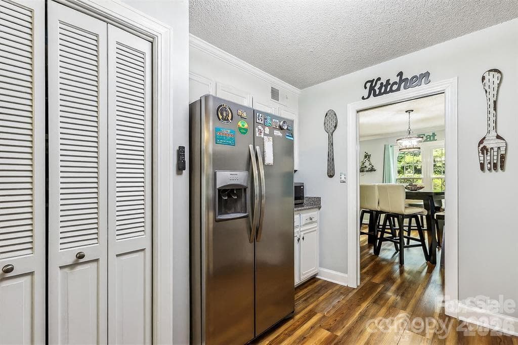 Dedicated pantry provides valuable additional storage, keeping everyday essentials neatly organized and within easy reach - 806 Colony Oaks Drive, Monroe