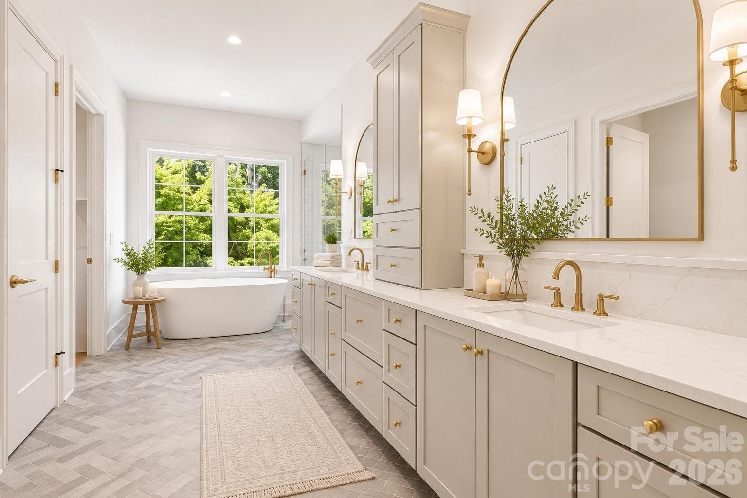 Light-filled primary bath with marble finishes, dual vanity and freestanding soaking tub. imagery has been thoughtfully enhanced to help communicate the architectural vision, lifestyle potential, and intended design experience of the home - 125 Randstone Court, Charlotte