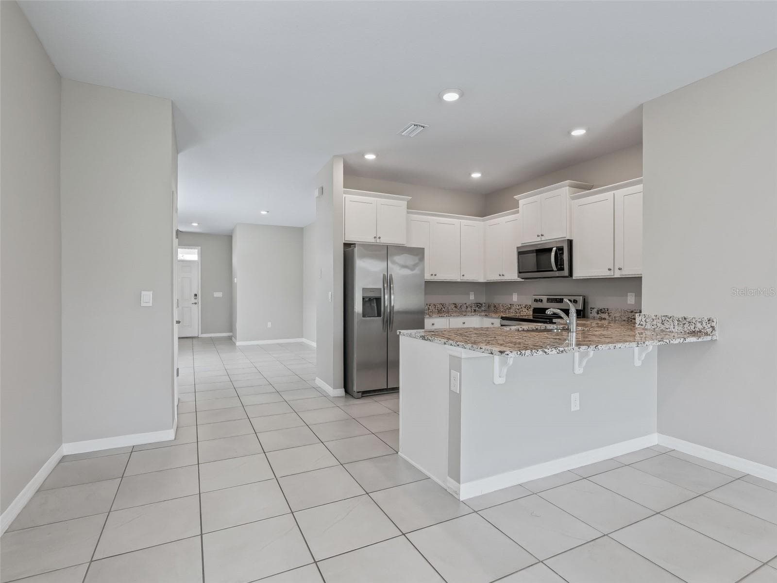 Kitchen looking toward the front door - 5072 STOKES WAY, WILDWOOD