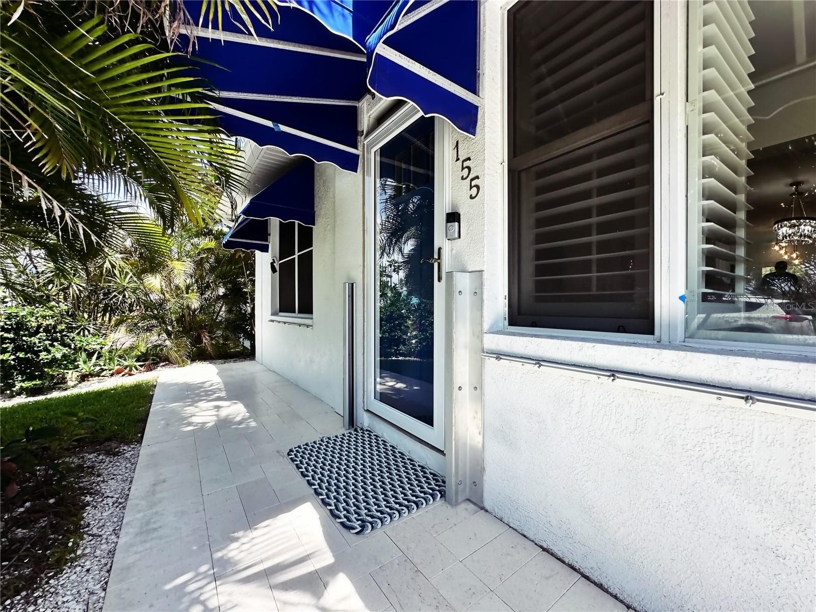 Front entrance. Note the flood gate brackets on the door. - 155 112TH AVE #A, TREASURE ISLAND