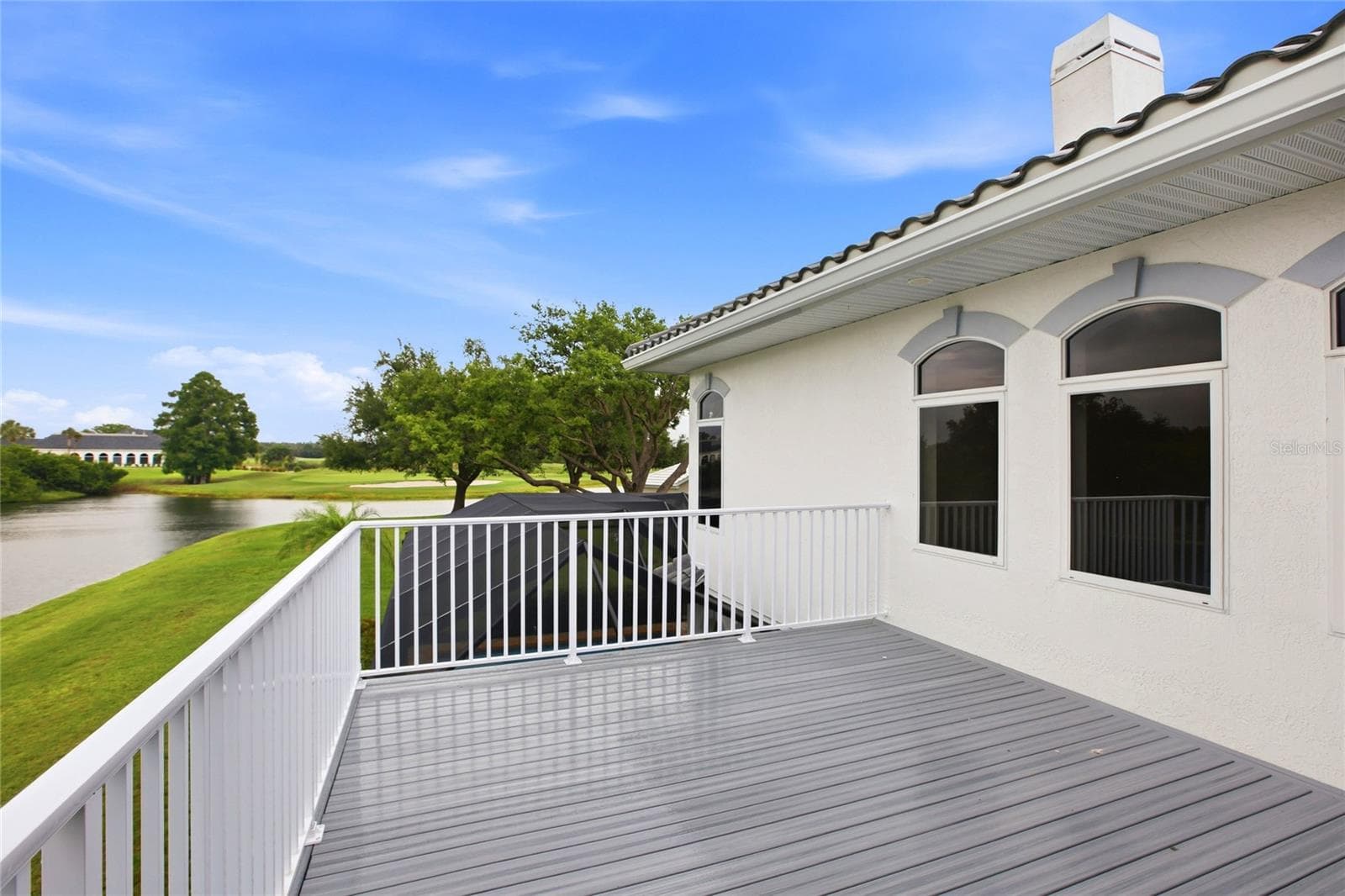 The upstairs balcony overlooks the lake and 18th Hole of Misty Creek. - 8417 LONE EAGLE WAY, SARASOTA