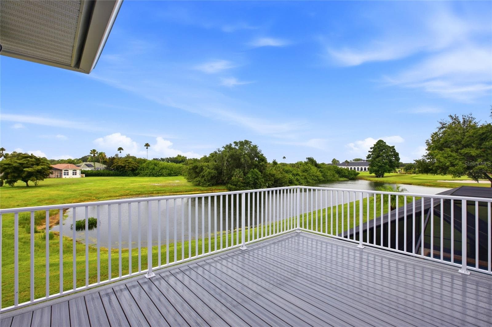 The upstairs balcony overlooks the lake and 18th Hole of Misty Creek. - 8417 LONE EAGLE WAY, SARASOTA