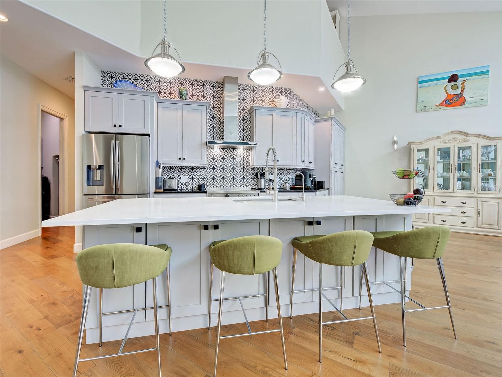 The kitchen island is designed as both a workspace and an eating area. - 5026 HANGING MOSS LN, SARASOTA