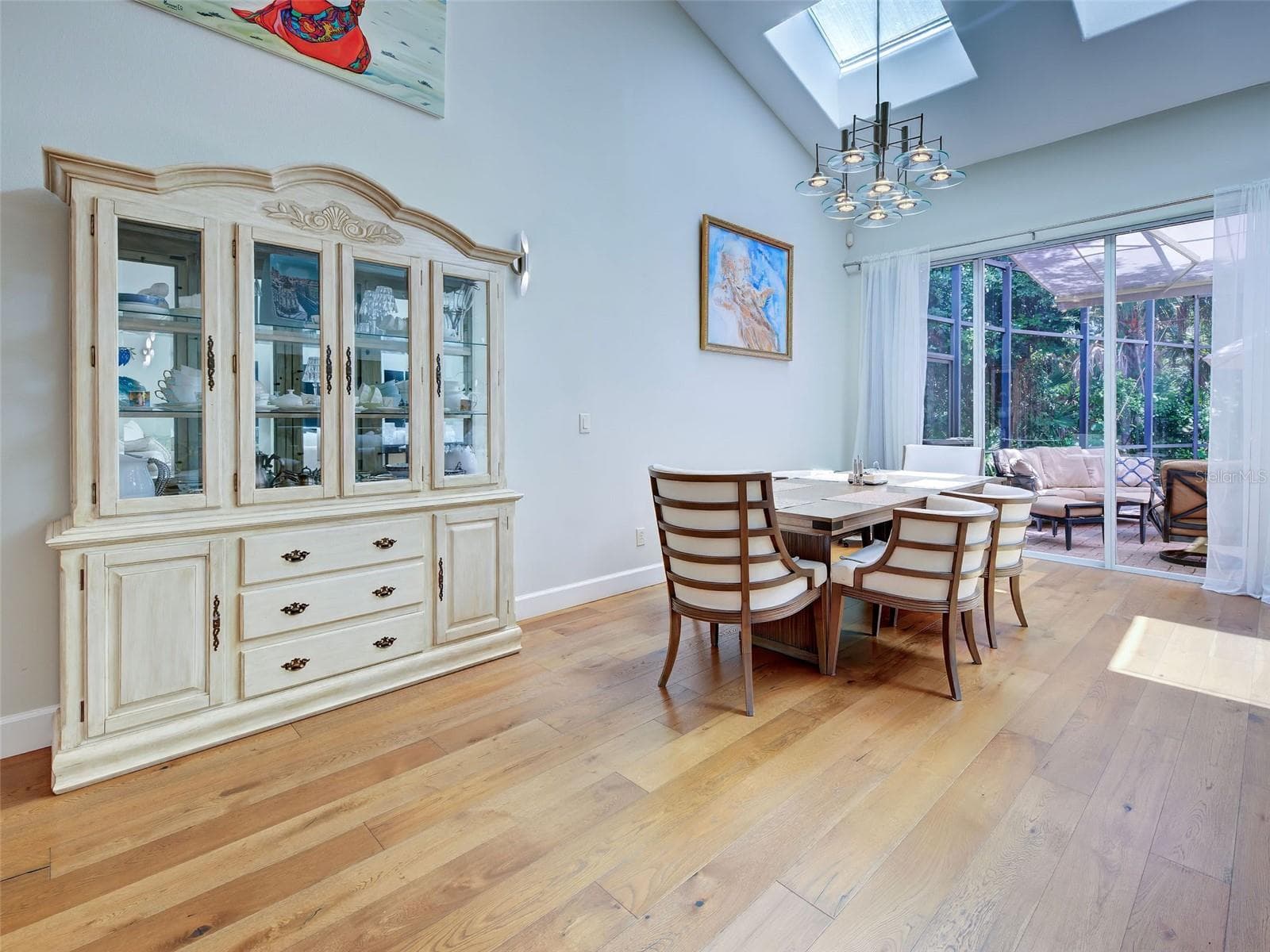 The dining area is adjacent to the kitchen with a sliding glass door to the lanai.  Easily move from working kitchen to meals at the table or dine outside. - 5026 HANGING MOSS LN, SARASOTA