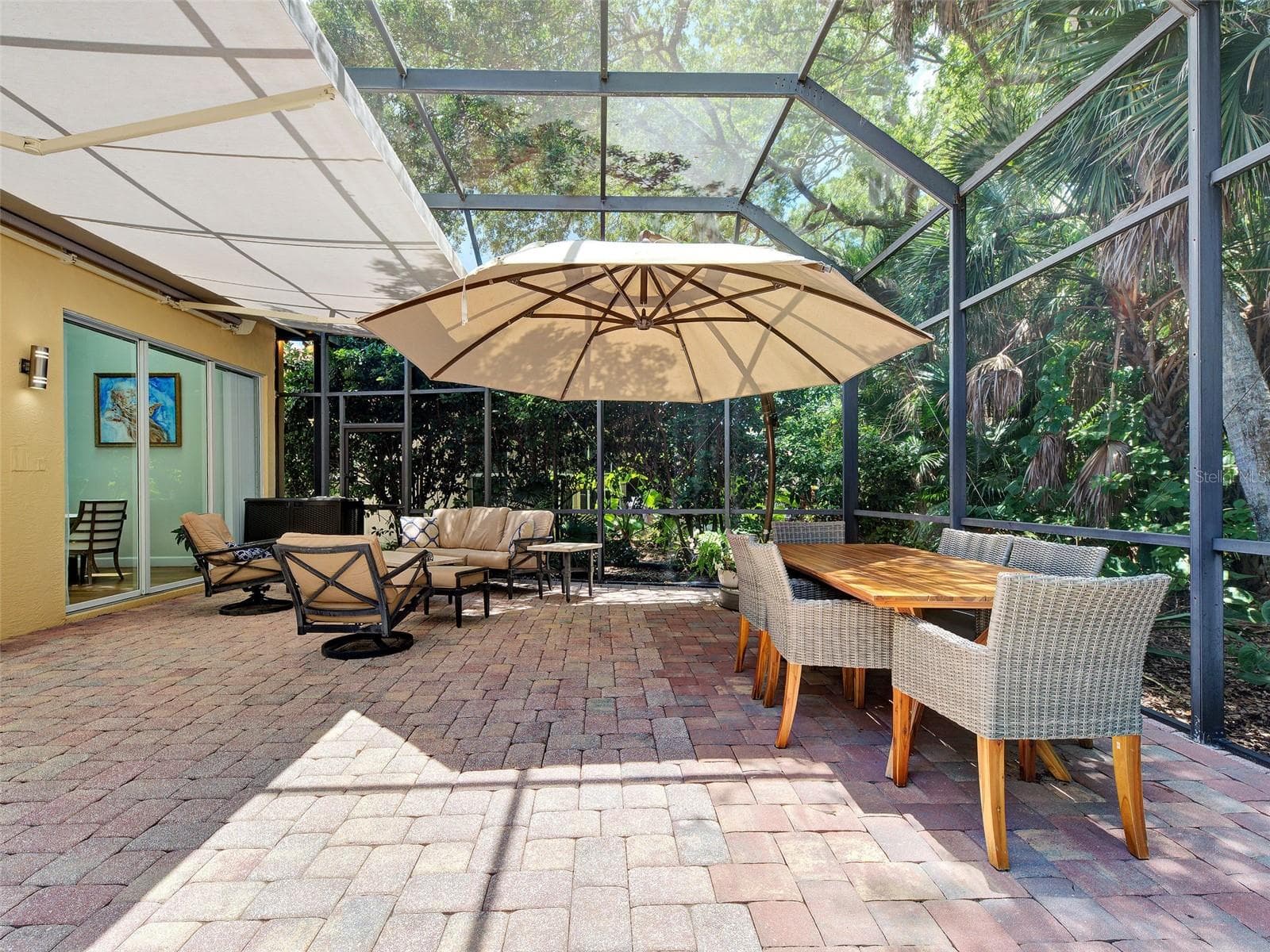 The spacious lanai with the Sunsetter motorized awning deployed.  Plenty of room to entertain and relax. - 5026 HANGING MOSS LN, SARASOTA