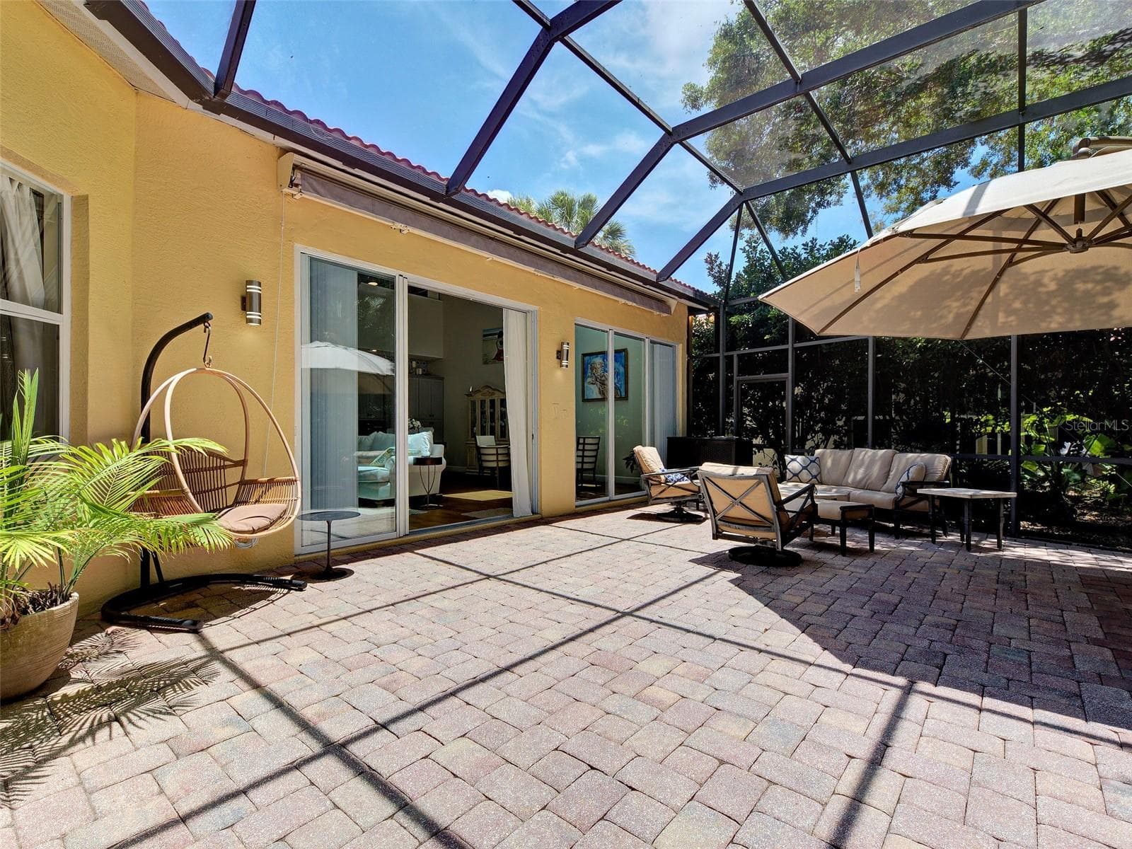 The lanai with the awning retracted creates lots of options for this lanai space. - 5026 HANGING MOSS LN, SARASOTA