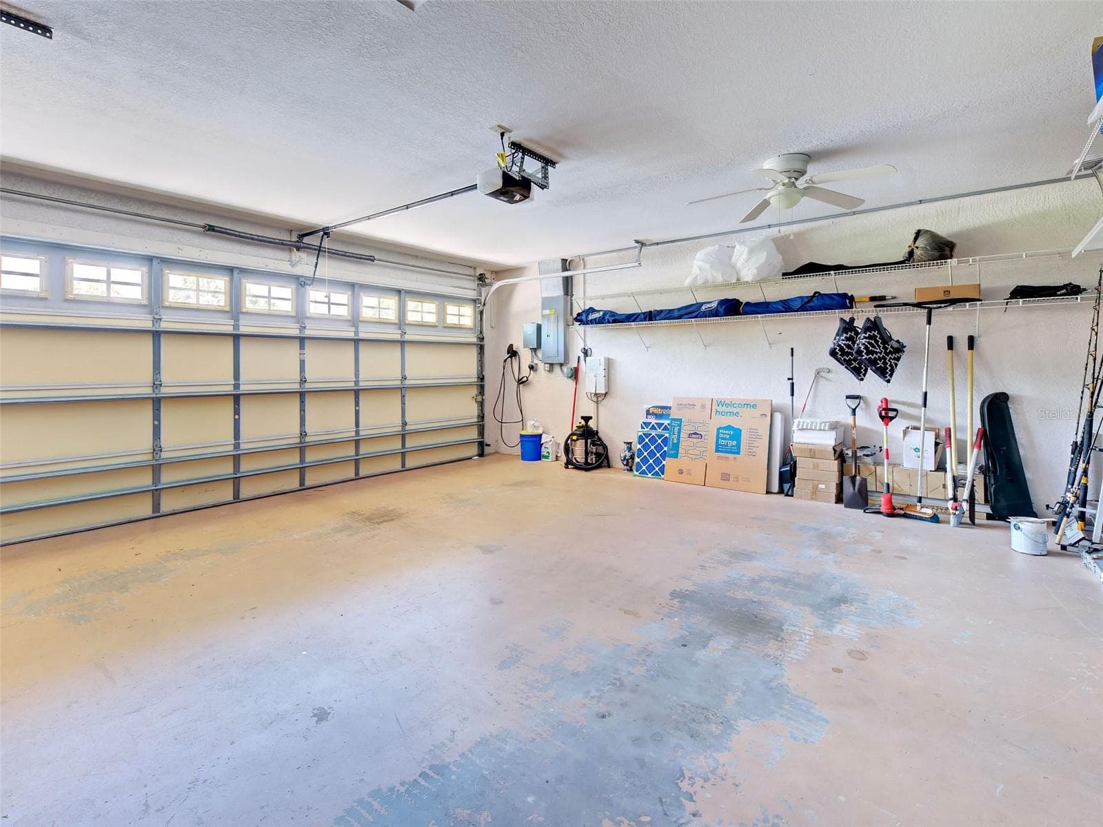 The three-car garage with a Tesla charger. - 5026 HANGING MOSS LN, SARASOTA