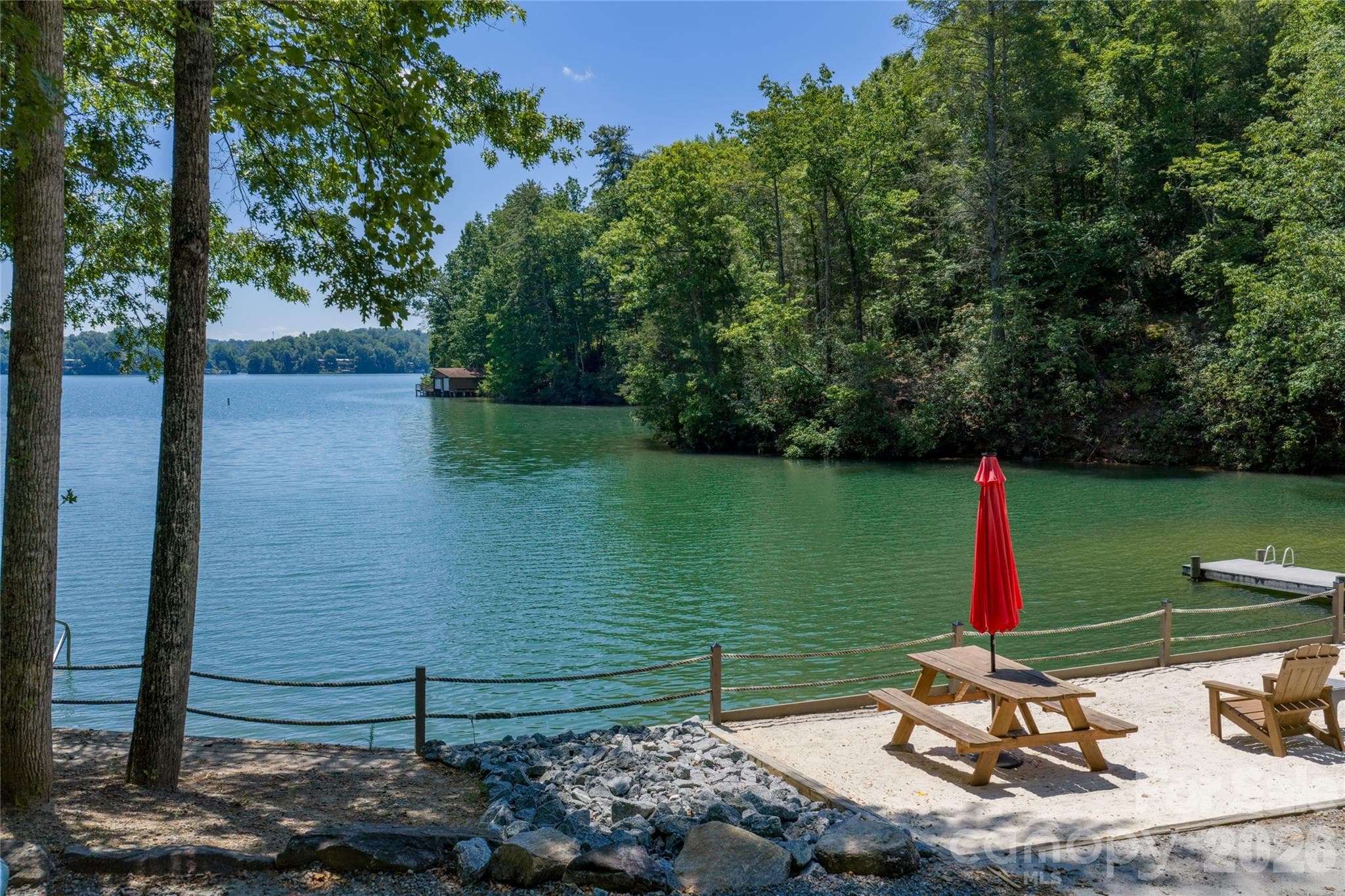 The property is steps from the beach access. - Lake Lure