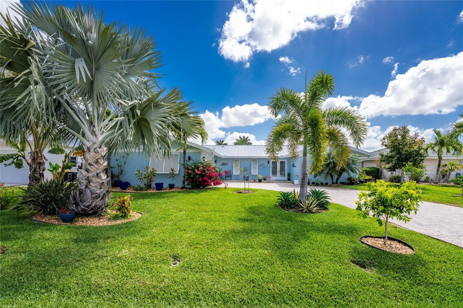 Mid-century charm meets lush grounds with a wide variety of tropical palms, flowering and fruit bearing tropical  trees. Blue and Mahoi Bananas, Meyer Lemons, Key Lime, Peach, Tangelo , Tangerine, Avocado - 80 SABAL DR, PUNTA GORDA