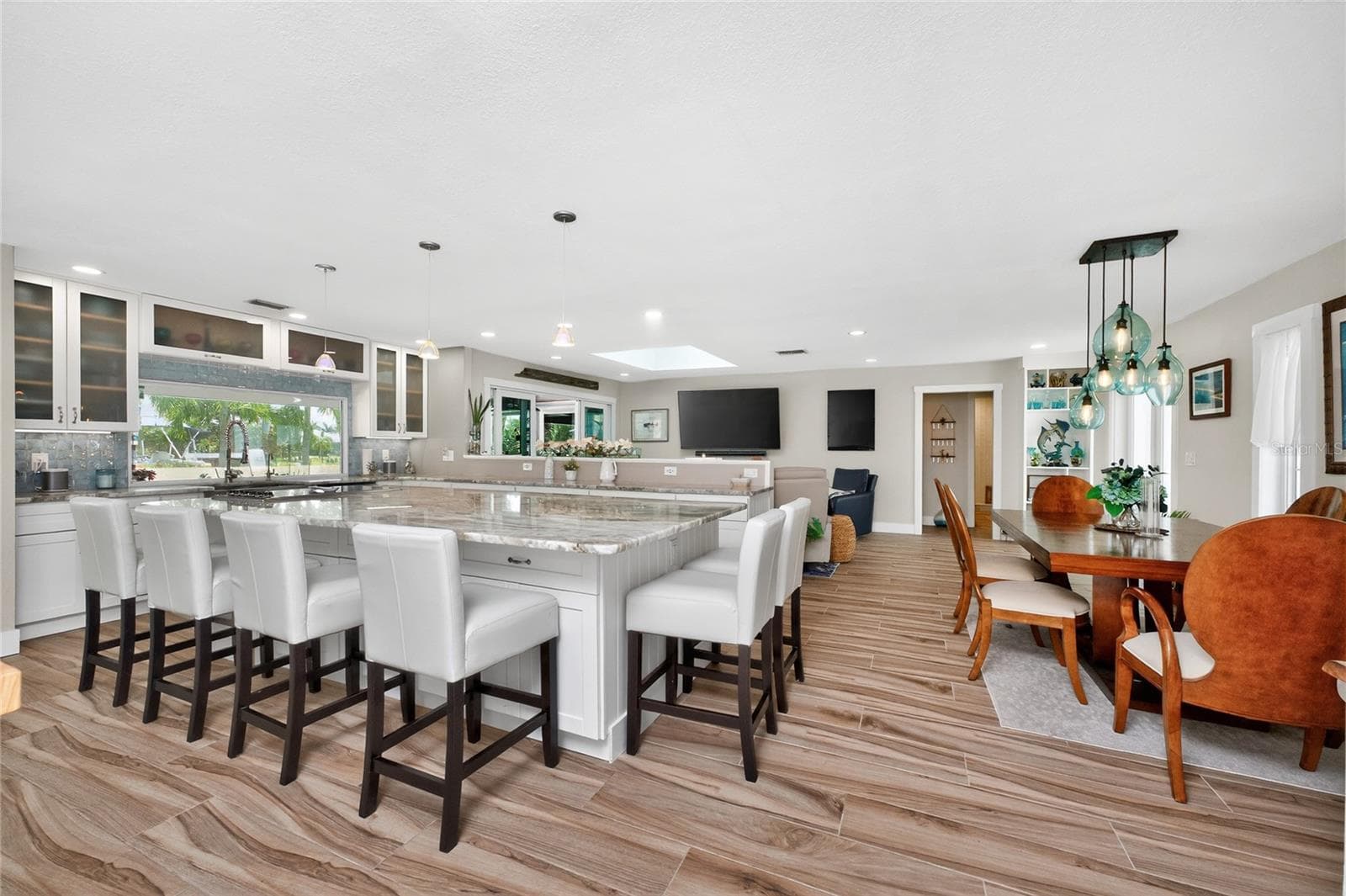 Bruck pendants and skylights pour light over every detail of this  open-concept design, where form, function, and finish come together in perfect balance. - 80 SABAL DR, PUNTA GORDA