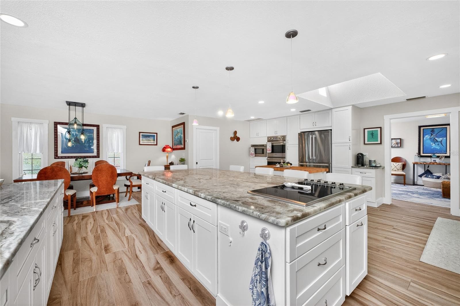 The island commands the room, anchored by a built-in Viking cooktop. - 80 SABAL DR, PUNTA GORDA