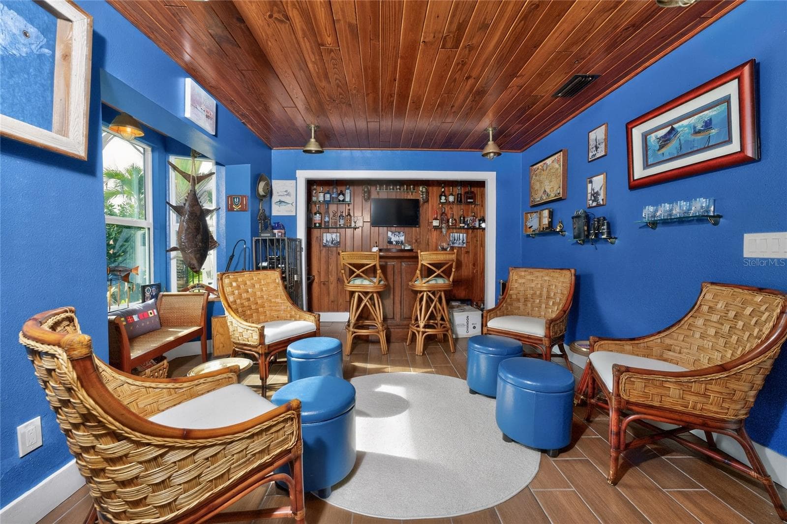 Reclaimed nautical lights catch the warmth of rich wood-plank porcelain tile floor — an ode to authentic maritime craftsmanship - 80 SABAL DR, PUNTA GORDA