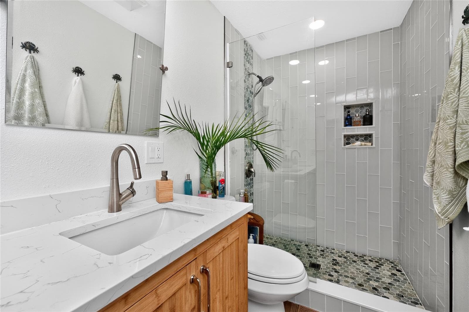 Bamboo, marbled quartz, a frameless glass shower worth lingering — every finish dialed in. - 80 SABAL DR, PUNTA GORDA