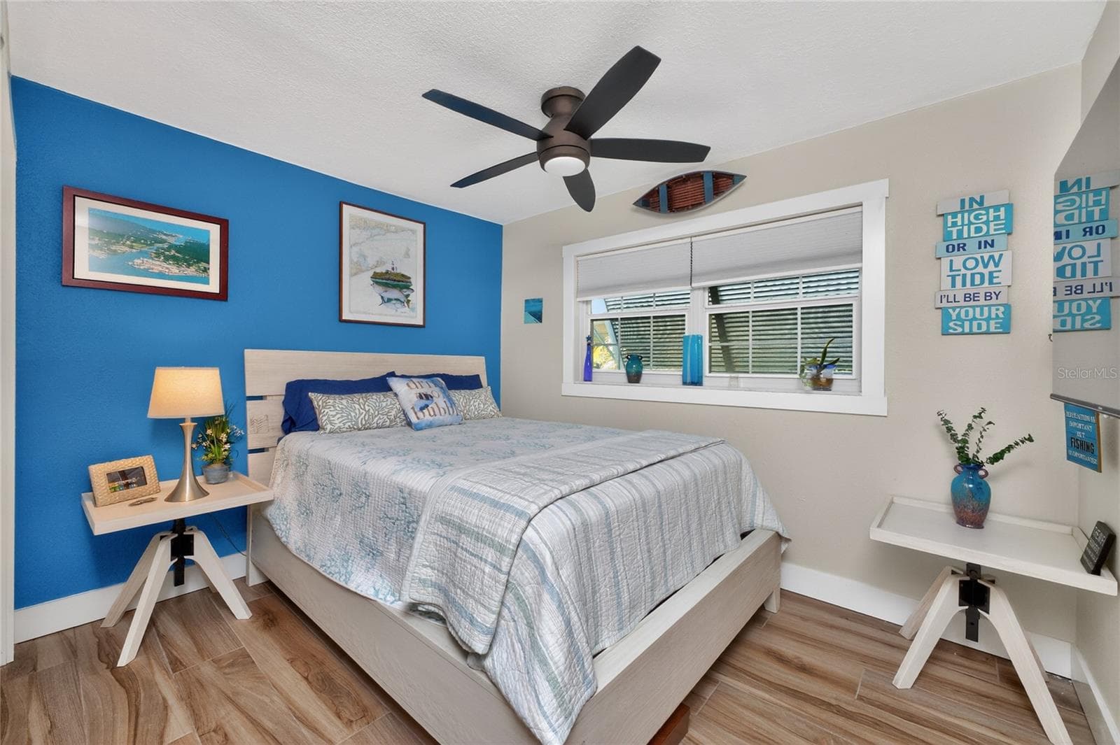This  coastal vibe is carried throughout the guest bedrooms with exterior bahama shutter for privacy - 80 SABAL DR, PUNTA GORDA